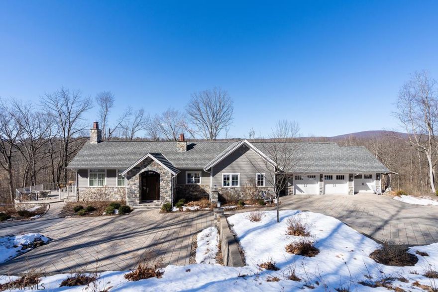 Enter this secluded mountainside property through a secured gate, proceeding along the lighted driveway to the spacious 2 level home featuring real stone veneer, Grand Manor shingles, walkways, patios and parking areas of paved stone. Hardy siding. High end security system, efficient in-floor radiant/geothermal heating.  HW floors on main level with designed concrete floors in lower level.  Built by McCloskey Builders in 2016. Natural cherry cabinets.  Three car garage with additional storage space. Kitchen features copper sinks, Wolf range, Subzero refrigerator, built in microwave, quartz countertops..   Propane FP in great room and kitchen area.  Enjoy the coming warm evenings on the deck or patios surrounding this gem.  Property serviced by public sewer and well.  Nicely landscaped.