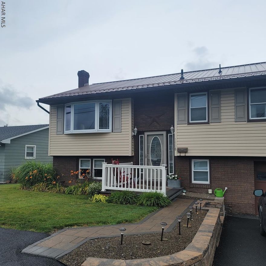 Here is your opportunity to move into one of Altoona's most established neighborhoods. Close to everything yet tucked away. Lovely bi level home with large rooms. Modern eat in kitchen, large dining room that could be used as a great room or multi purpose room that opens to an expansive deck so you could enjoy your evenings. All the bedrooms are very large and have large closets. Lower level has a family room with a wood burning fireplace. There is also a space for a mini home gym, or office. Convenient half bath on the lower level as well as laundry.  New metal roof, new central air, beautiful landscaped yard and paver sidewalk as well as paver front porch patio. This house has to be seen to be appreciated, its a lovely home and wont be around for long. Call today for your private showing