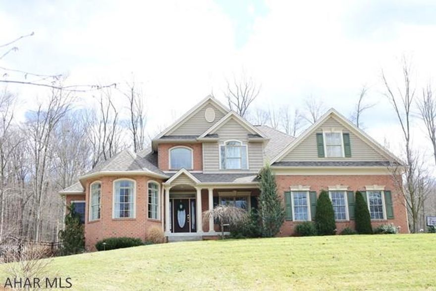 Stunning custom home situated on 4 beautiful acres...complete with heated salt water pool, pavilion and summer kitchen.  The home has abundant quality features from floor to ceiling...hardwood floors, vaulted ceiling in the Great Room, Mennonite made kitchen cabinets and stainless appliances.  The first floor is warm and inviting due in part to the double sided fireplace and the view of the Tussey Mountain waterfall in the backyard. Master Bedroom is spacious and has a tray ceiling and a sitting area...open the door to the patio and have the waterfall lull you to sleep.  Lower level is nicely finished with a bar area...living area with stone FP and a rec area, too.  Open the doors out to the inground, heated, saltwater pool..this area boasts a kitchen pavilon, perfect for Summer barbeques.