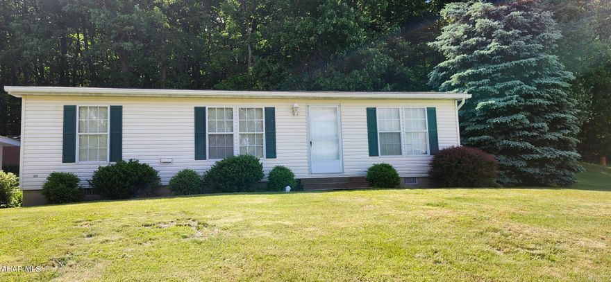 Wonderful rural location for this 3 bedroom, 2 bath one-story home. This well maintained home is on a permanent foundation and includes a covered rear deck, carport and a shed. The backyard is bordered by a wooded area. One story living at its finest for the buyer who is looking for one level, to downsize or just starting out.