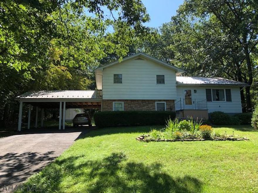 Very Private Setting is a 3 Bedroom 2 Bath Split Level on wooded 1.38 acres.  New Well Pump in 2018, New metal Roof and Gutters in 2019, and New Furnace in 2020.  Large 2 car covered carport with new metal roof and screened in Back Porch for entertaining and a storage shed in the back.  If you're looking for privacy there's only one house within view!  Call me for a showing!!  Doug