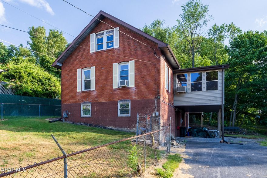 Sheetz old carriage house! Needs work but has unique qualities that can be revitalized...Double brick walls, balcony from main bedroom with parquet flooring. Bonus Room has knotty pine ceiling and brick walls with spiral stair case to loft. Large kitchen with eat in, leading to large sunroom with parquet flooring open space with view of mountains and Altoona. 2nd bedroom with dressing area.
