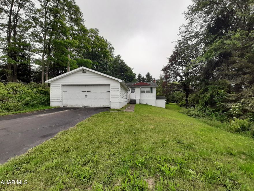 Great starter home on a lovely 2 acre parcel. This 3 bedroom and 1 full bath home offers an eat in kitchen, bright living room, and 3 comfortable sized bedrooms and of course a full bath all on 1 level. The lower level houses the laundry and a bonus room. The 2 acre parcel boasts a 2 car garage, mature trees, and a large barn/shed. Plenty of yard and plenty of privacy! Newer furnace and windows, plus original hardwood floors. Call for your tour today!!