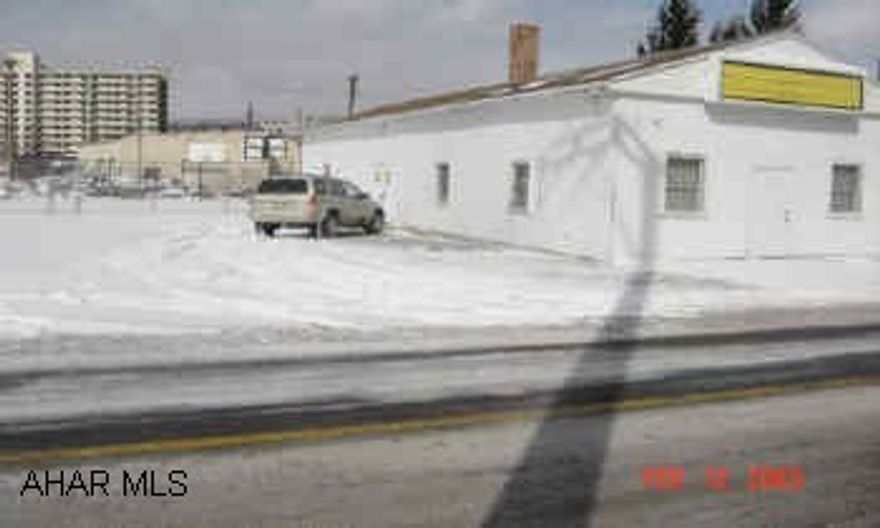 1 story 25x80' building with large parking lot and fenced area.  Zoned highway business.