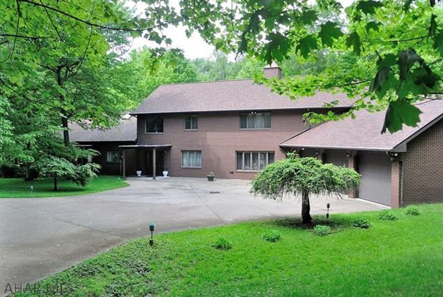 Expect to be impressed....quality built, rambling home with plenty of space for everyone! 2 Story foyer, rustic living room boasts a vaulted ceiling, stone FP and lots of light...wooden steps lead to a loft area.  The Owner's Suite is sure to wow you....large enough for a complete living space....and another FP., adjoining Bath has a jetted tub and a walk in Sauna.  There are 3 other bedrooms, a full bath and a large walk-in storage area on the 2nd level.  Another bedroom and bath can be found on the first level.  Family entertaining is a breeze in the enormous Family Room...complete with a large wet bar and FP.  Step outside to the picnic spot, walk the lane to the pond and warehouse/man cave...great for equipment storage...big enough for RV storage PLUS!!!  Must be seen to appreciate!