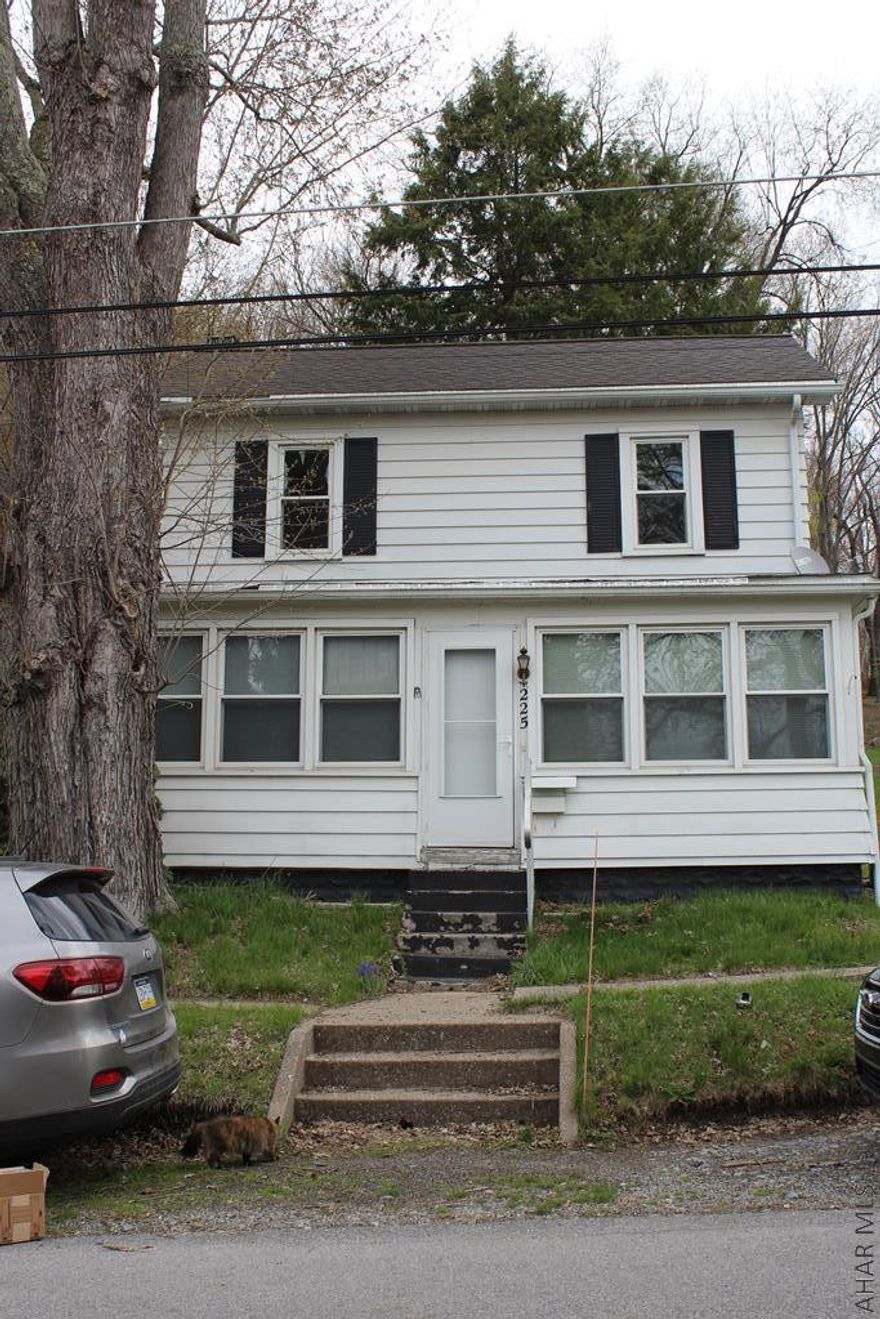 As you enter this home through the sun room, you'll see this 2 story home w/ central air, is spacious!  Ceiling fans throughout.  The family room has wood floors. Timeless craftmanship in the large kitchen with eat in area, has many windows that filter natural light.  First floor laundry room w/ half bath.  The mudroom is perfectly placed for entering the large fenced in backyard. Shed in backyard stays with home.  Full bathroom upstairs is large with linen closet.  The left side of the home can be used to create driveway w/carport/ small garage.  This home is centrally located in Phillipsburg, 30 mins from State College.