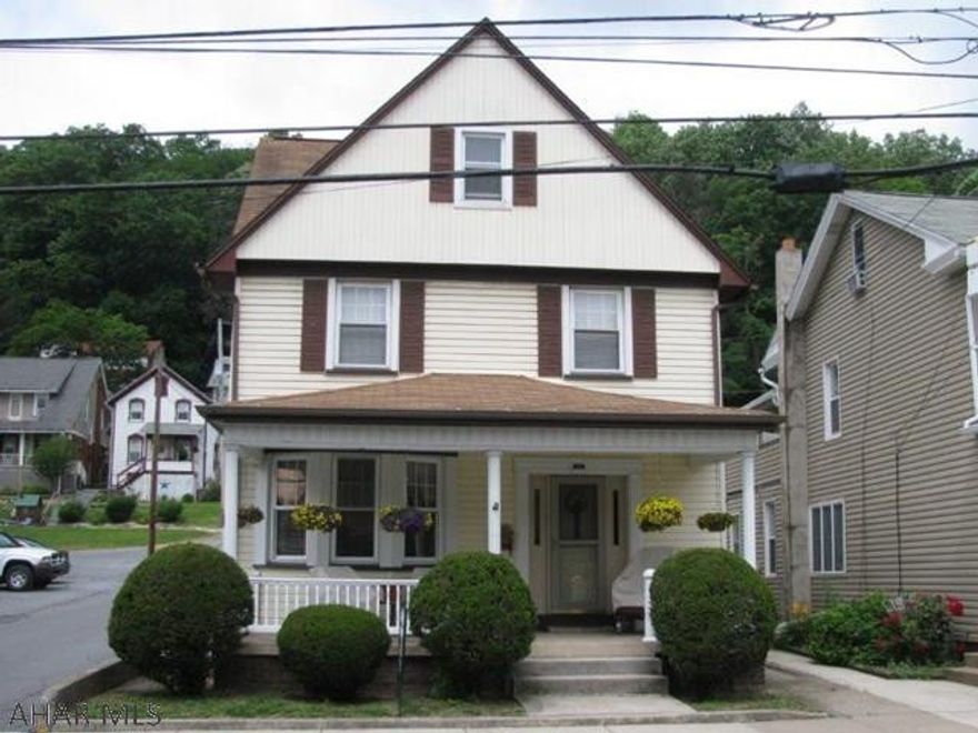Watch the parades from your front porch or cross the street to the park! 2 1/2 story maintenance free Tyrone home w/ carport and detached garage. This home offers a spacious LR., DR.,  w/custom Cherry corner cupboard, EIK. w/ custom solid cherry cabinets, 1st fl. laundry and 1/2 bath! 2nd flr features 3 bedrooms and full bath plus a 2nd flr porch! Walk up attic storage & finished area in the basement too!! New furnace and updated windows, roof, siding and porch!!