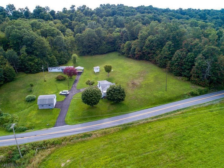 Gorgeous acreage with a 2 bedroom home with large carport and 2 bedroom trailer with large carport. Well maintained home. House and trailer on separate well and septic.
