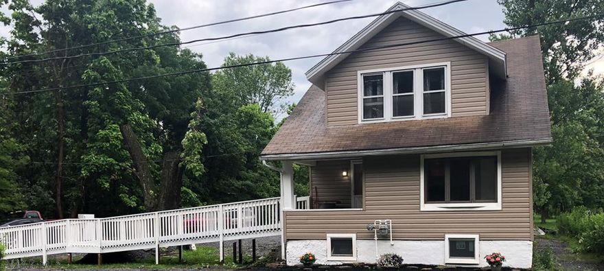 2 1/2 story home on approximately .75 acres. New vinyl siding, updated kitchen with recessed lighting hardwood floors and stainless steel appliances, new flooring, updated bathrooms, 1st floor laundry with new washer and dryer.  Handicap accessible.