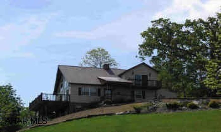 Contemporary home with panoramic mountain views, wrap-around deck, patio, secluded site. Cathederal ceilings, wood beams, open floor plan, family room has wet war, wood burner, French doors open out onto patio.