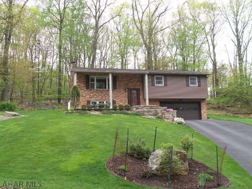 Don't miss this beautiful home nestled in a wooded setting. This house is the definition of "move in" condition. From the new, solid hardwood flooring, the stunning updated kitchen with all stainless steel appliances and all updated baths. The lower level family room features a gas log fireplace, updated 1/2 bath and large laundry room. Don't miss the large two car garage with new insulated top of the line garage doors.  Please make note of the utility costs and low property taxes! If searching for an exclusive neighborhood with a quiet setting don't miss this one.