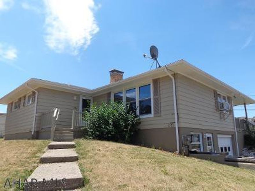 This attractive house has so much to offer!  Spacious fenced in yard on 4 city lots, hardwood & ceramic tile floors, 1 block away from a park, partially finished basement, fireplace, garage, updated electrical.  A great location and a great home for you!  8 years left on a transferable warranty from Terminix given to buyer.