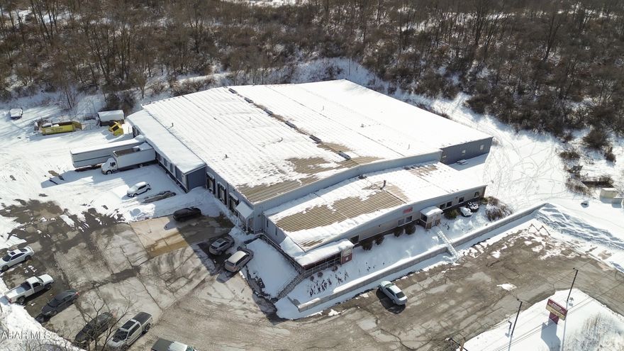 Prime Light Industrial (L-1) property with frontage along Eisenhower Boulevard, offering approximately 42,220 SF of functional industrial space on ~ 4.3 acres. The facility includes 25,200 SF of original manufacturing space, a 10,560 SF warehouse addition, 5,200 SF of finished office/showroom space, and a 1,260 SF covered loading dock. The front office area features reception, conference room, private offices, employee lunchroom, and multiple restrooms with gas forced-air heat and central air. The manufacturing and warehouse sections provide open work bays with 14' ceilings (12' in the addition), concrete floors, and 10 overhead doors for efficient loading and workflow. Infrastructure includes a 600-amp, 3-phase electrical service, wet sprinkler system, compressed air system with three air compressors, and multiple gas-fired heaters. The addition also features electric radiant floor heat. The steel-framed structure offers brick and decorative finishes at the showroom facade, paved parking, partial fencing, and full public utilities (water, sewer, electric, natural gas). A well-equipped, high-capacity industrial asset ideal for manufacturing, warehousing, or distribution operations. Call today for more information!