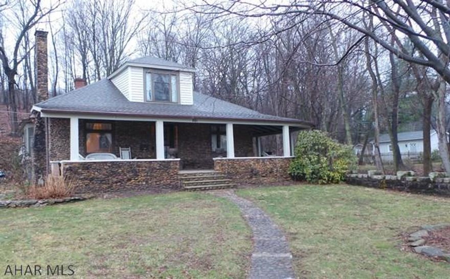 See map in docs for lot size. Price includes 3 lots. Unique Riverstone home with 4 bedrooms, 2 baths, large rooms, gas fireplace, bonus room with built in bookcases and door to wrap around porch. Gas hot water heat and central air. New roof 2016. Sit on the wrap around porch or covered patio and listen to the soothing sound of the creek.   Flood insurance estimated quote is $1122 based on 125,000.