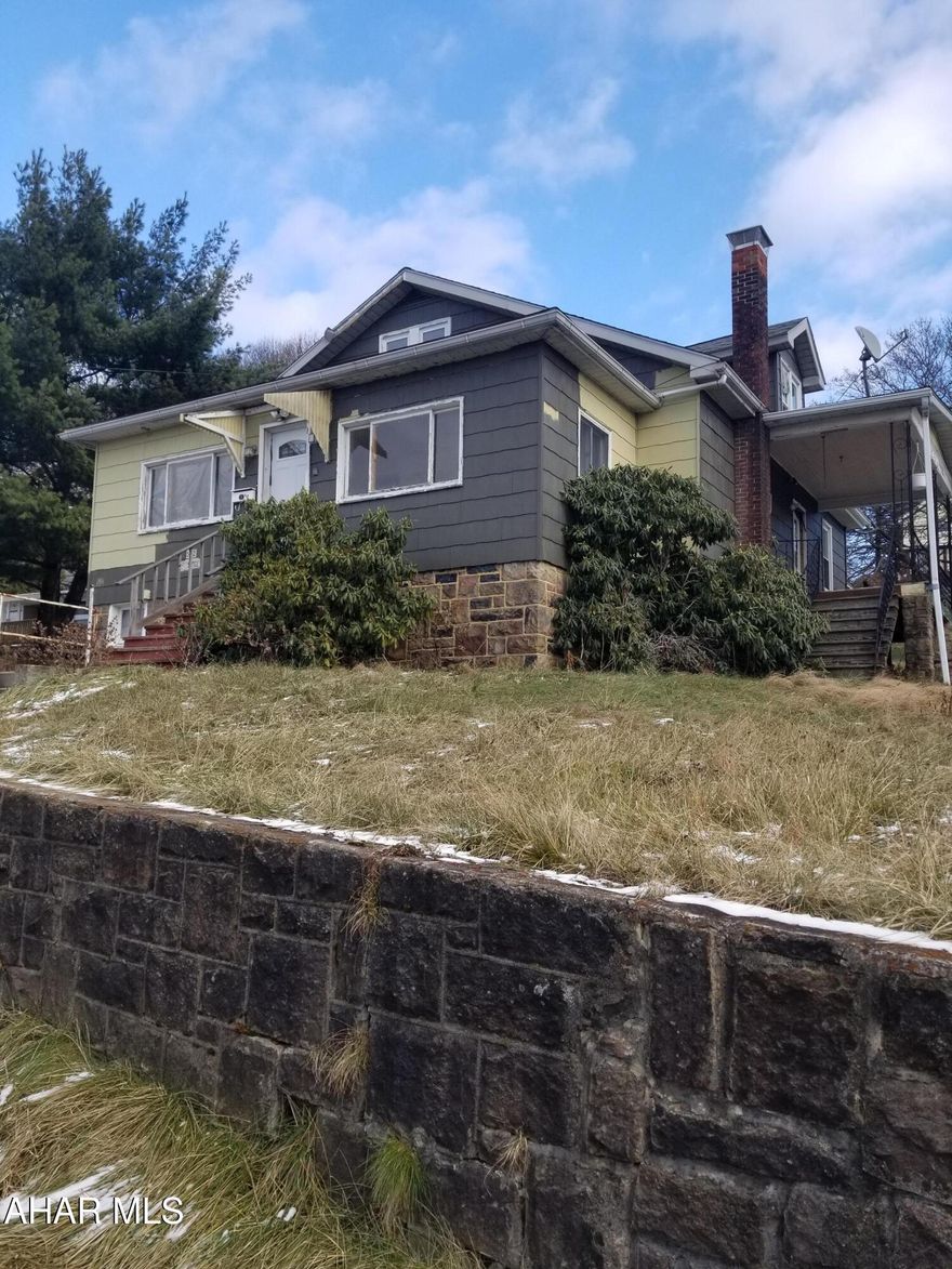 Larger than it looks! 4 bedrooms , 1.5 bathrooms and a large kitchen. Main floor has new luxury vinyl flooring, upstairs has new carpet. Just add a few new finishing touches to call it home. Huge yard with a stone fireplace in the yard with a cozy side porch make this home inviting.