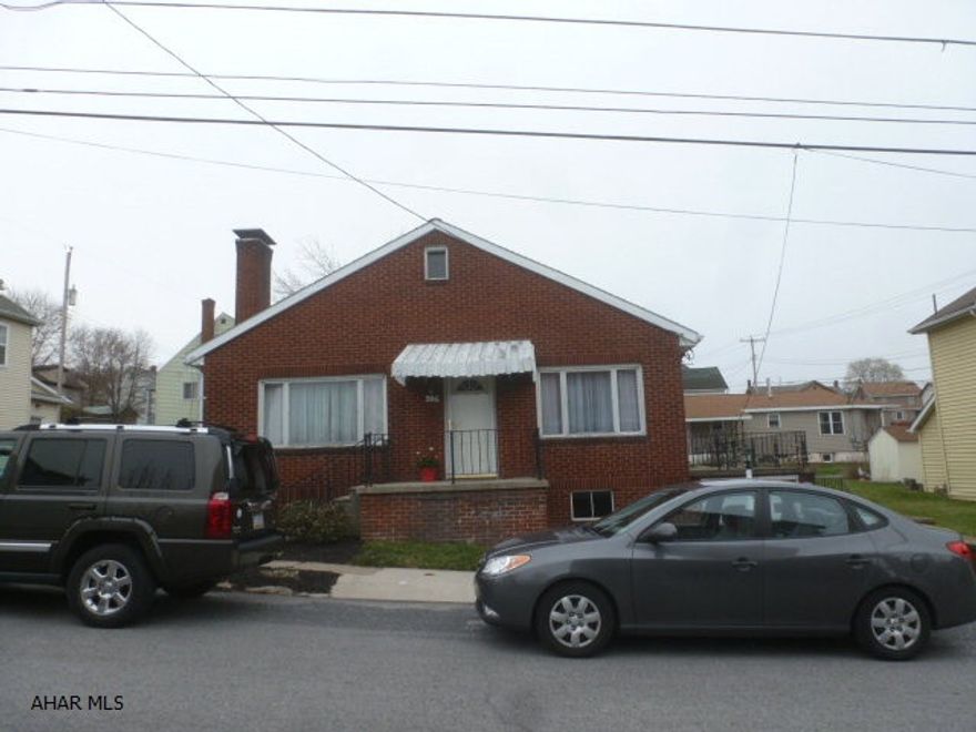 The property has a newer roof, new furnace, plumbing and new insulated doors.  The living room features a wood burning fireplace, hardwood floor under all the carpeting and a partially finished basement and a heated driveway.  There is a wood burner in the basement.  The basement flooring and has been removed.