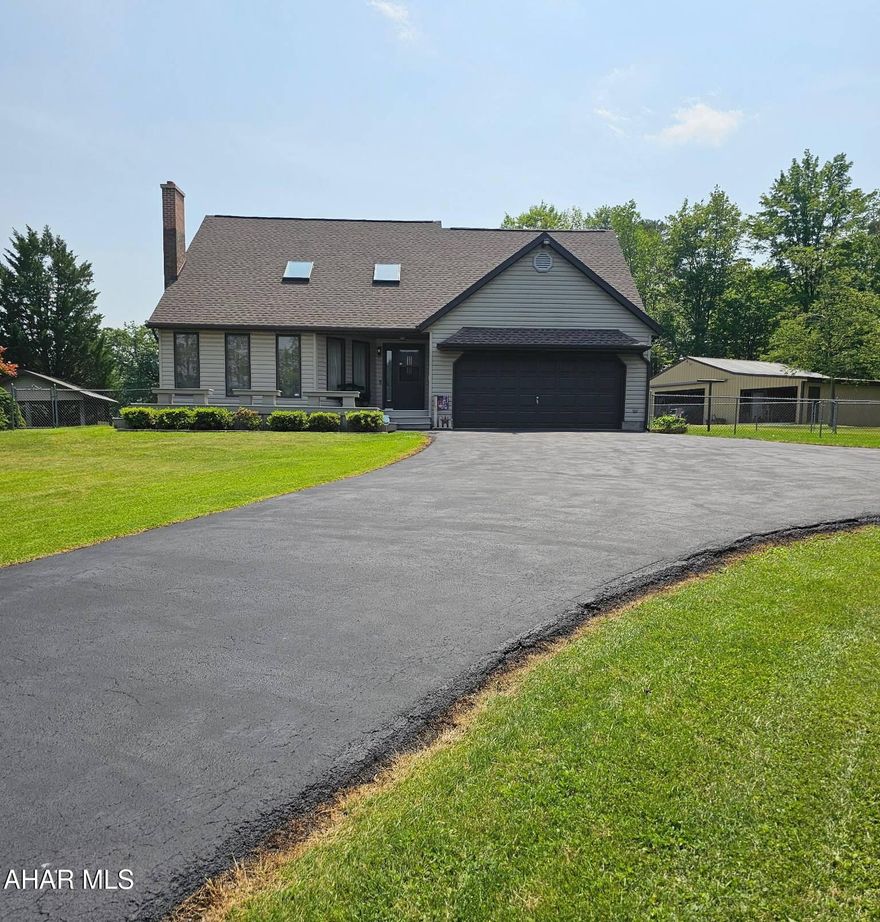 Welcome to this stunning contemporary home set on 2.88 private acres with beautiful rolling hill and field views. The open-concept layout features a light-filled living area with soaring ceilings, new skylights, and a 4-year-old roof. The sleek, modern kitchen includes a large island, huge pantry, custom cabinetry, new cooktop with wall ovens, and a gas line for easy conversion back to gas if desired.

The spacious first-floor master suite offers a sitting area and en-suite bath. Additional bedrooms are generously sized, with a flexible upstairs space that could serve as a 4th bedroom or bonus room. The finished lower level includes a large family room and custom entertainment cabinetry. A convenient first-floor laundry room features a pocket door and built-in storage.

Outdoor living is a highlight with a 22x18 pavilion (brand new roof and electric), a 25x47 concrete patio with gazebo, and a large fenced yard—ideal for entertaining or relaxing.

Storage and workspace abound with an attached 2-car garage, a 46x30 secondary metal garage with new addition, 100-amp subpanel, concrete floor, shelving, two sheds, and all new garage door openers (two with battery backup).

Recent updates include renovated bathrooms, updated boiler, water softener with UV light, radon system, generator wiring, and neutral finishes throughout.

This move-in-ready home offers the perfect mix of space, style, and privacy—don't miss it!