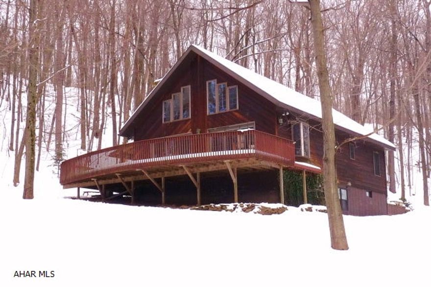 A cozy 1 1/2-story 3BR/2 full a half bath rustic cedar-sided chalet style home in a picturesque 4.9 woodland country setting with stream and small pond. The main level offers an open floor plan with cathedral ceiling, exposed wood beams, kitchen, dining room and living room with a natural stone fireplace. Loft MBR suite overlooks the great room. The walkout basement is finished with laundry room, small office and family room. The over-sized detached 3-car garage features a second level shop/storage area with an attached office/studio.