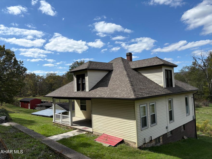 This well-kept farmhouse is beautifully situated on approximately 6 scenic acres with roughly 300 yards of frontage along Dunnings Creek and is located less than four miles from the highly sought-after Chestnut Ridge School District. Whether you are raising a family and want to be close to the schools, an outdoorsman searching for your own hunting and fishing retreat, dreaming of a small farmette lifestyle, or simply looking for the perfect weekend getaway this property deserves your attention.
The main level offers a spacious kitchen, two bedrooms, and a full bathroom, along with a generous living room and charming front-facing parlor,  ideal for comfortable everyday living. Throughout the home you'll find beautiful original moldings, window casings, doors, and built-ins that preserve its timeless character.
Upstairs features two additional spacious bedrooms, a walk-in closet, and a bright hallway window that brings in natural light.
The partially finished basement includes two separate walkout doors to the backyard, a large, enclosed room perfect for canning or a wine cellar, a classic Pittsburgh toilet, and ample shelving for storage.
Outbuildings include a 32' x 24' detached two-car garage, an 82' x 18' pole barn ideal for hay, farm equipment, or camper storage, and a 14' x 36' masonry livestock shelter.
Located in the backyard of everything the Chestnut Ridge School District has to offer and just about 20 minutes from the restaurants, shopping, and charm of historic downtown Bedford, including the renowned Omni Bedford Springs Resort & Spa, this property is well suited to a wide range of buyers and lifestyles.
Schedule your private showing today and experience it in person.