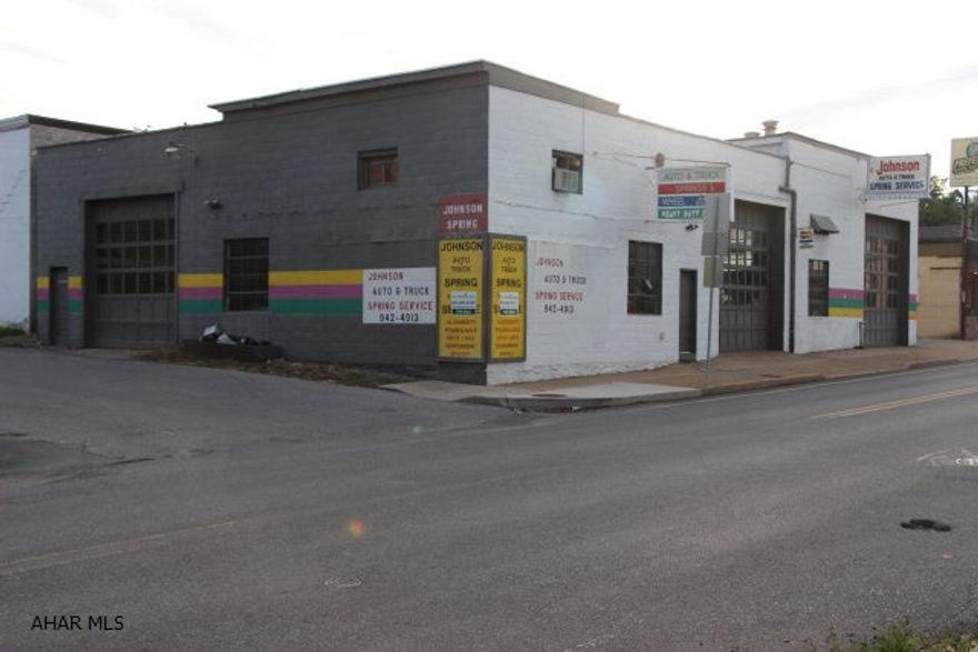 This building is located in a busy traffic area and is perfect for many types of businesses! Approximately 4000 sq. ft., zoned light manufacturing with 3 over head doors (2 12 ft. & 1 14 ft.). Heavy lifting enabled with fixed gantry bay sized lift frame and 5 ton mounted trolley chain hoists. One 1/2 ton crane & two 1 ton trolley chain hoist. 220 volt 3-phase electric. Two offices, large storage basement and High Tech security system!  This commercial property is priced to sell, call today!