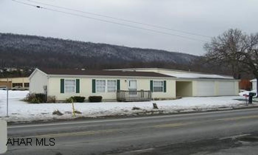 Like new 2000 Doublewide on cement block foundation, 3BR/2BA, central air, 2 car garage on easy care level lot with mountain view.