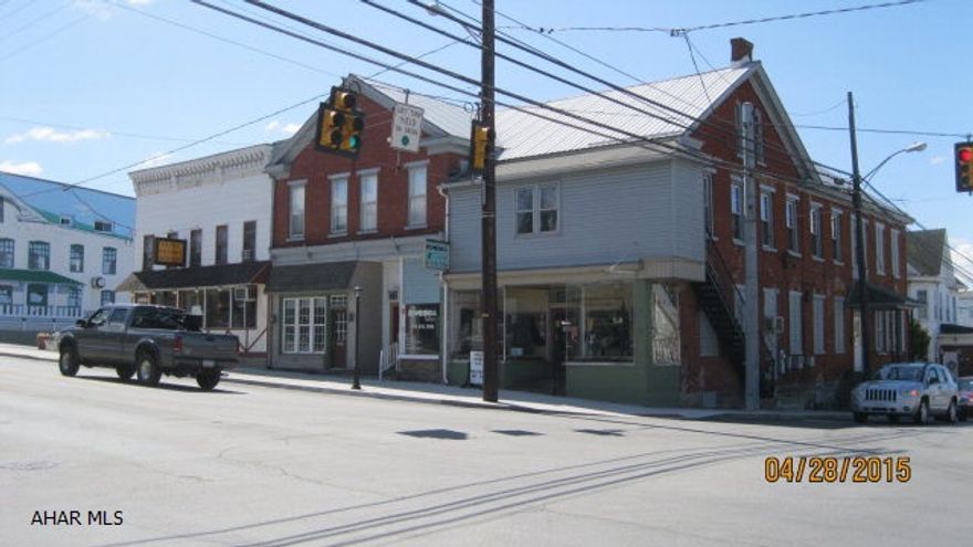 Three 1st level store fronts, two upper level apts and a nice 3BR owner apt.