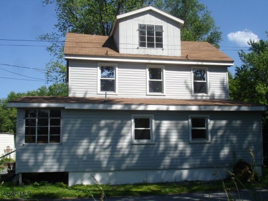 Interior totally redone. Fresh paint and new flooring throughout. New kitchen with new refrigerator and glass top stove. First floor laundry with stackable washer/dryer. 5+/- acres in quiet country setting. Owner is Licensed Real Estate Agent.