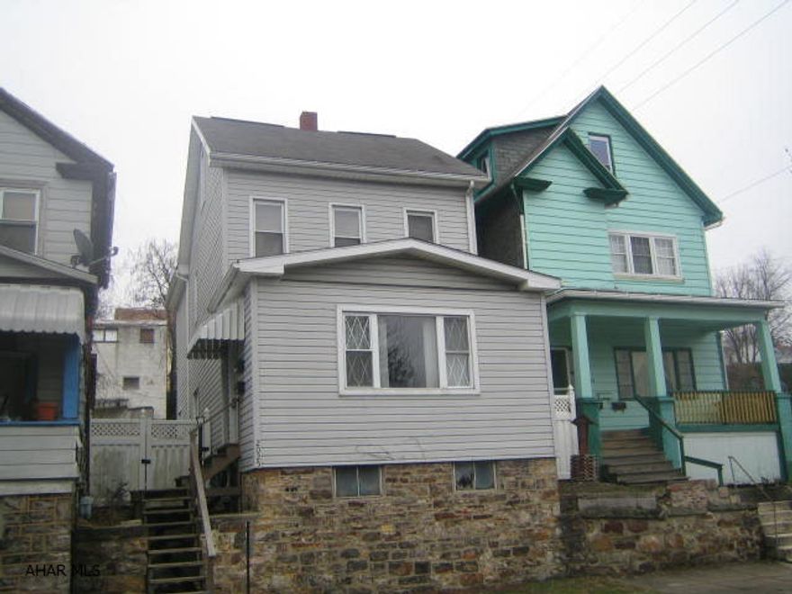 2 1/2 Story vinyl home with thermo windows, large living room, formal dining room and eat-in kitchen. Nice back yard and 2 car detached garage with newer overhead door. 100 amp breakers and newer hot water tank. Needs some TLC, but perfect for investors or first time buyers.