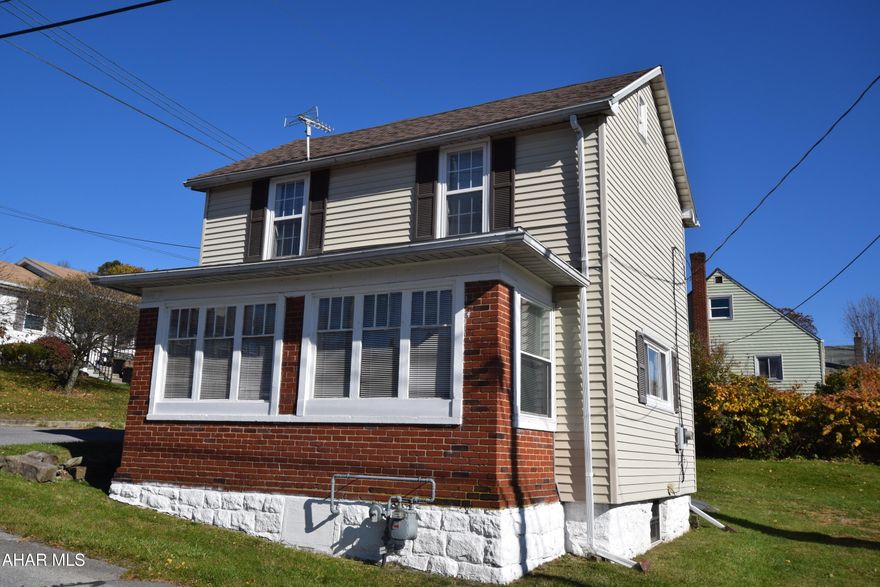 Great home for first time buyers or downsizers.  Spacious retro kitchen, living room, and bonus tv room or den on first floor.  Convenient mudroom at rear entrance and enclosed front porch for extra space in the front.   Second floor features large bedroom with electric fireplace, two additional bedrooms, and full bath.  Basement is clean and dry.  Laundry and .25 bath is located here.  Yard is large enough for play area for children and/or pet space.   New furnace, new hot water heater, newer replacement windows, Roof installed 2022!!   All high ticket price items have been taken care of.   So go for it!