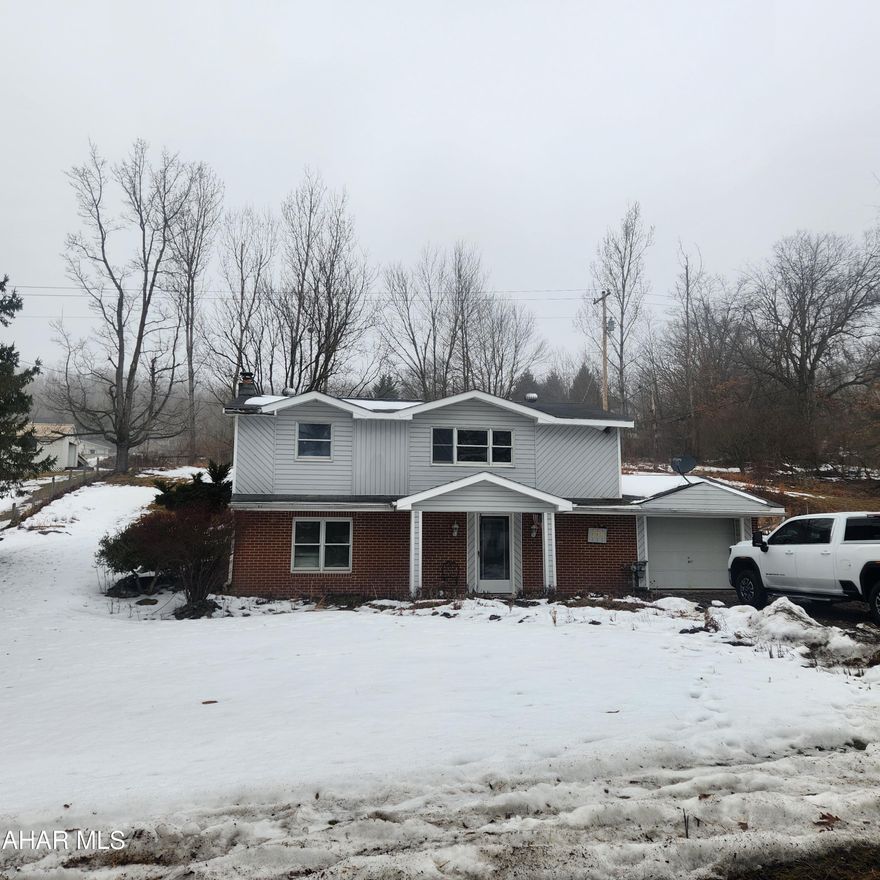 So much potential in this charming home on Brush Mountain Rd, Hollidaysburg. The main floor offers 3 bedrooms, a bathroom, and a kitchen with an island. Off the kitchen is a screened porch leading to the backyard. The lower level offers an entertaining room with a wood burner, a maintenance room, a half bathroom, and laundry. A one car attached garage also enters into the lower level. The sloping lot has previously been landscaped and offers a large shed. The furnace has recently been serviced and a part installed. Property sold in as is condition. Estate to make no repairs. Call listing agent for more information.