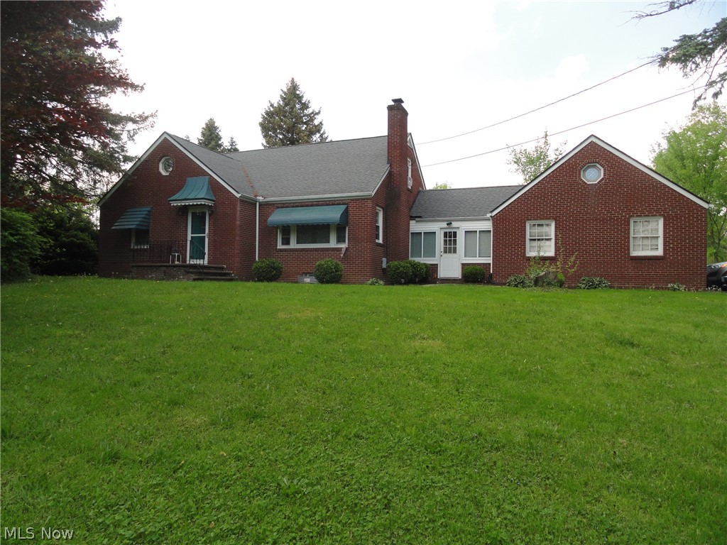 Charming brick Cape, living room with fireplace, arched doorways,2 bedrooms on the first floor, one large bedroom on the second floor. Cozy sunroom between house and garage. Full basement with 1/2 bath. Concrete patio. Attached garage has second floor storage area. Nice home, convenient location.