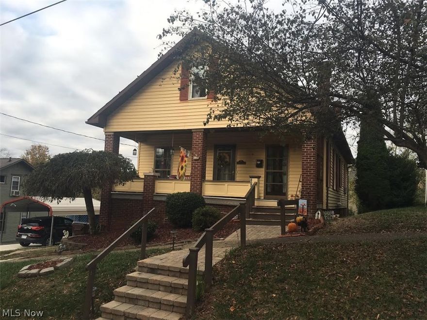 Cute as can be! This darling 1.5 story brick and vinyl house has had quite a facelift in past few years. New kitchen with Hickory Cabinets, new counter tops and stainless steel appliances. Bath has been remodeled and been handicap modified as well. Laundry has been moved to first floor so one floor living is possible. Awesome covered front porch! On additional lot owners have just added a new concrete driveway and 1 car carport.  Original driveway is still there also so lots of off street parking. Must See This One!  Great home for the money. P940 JJ