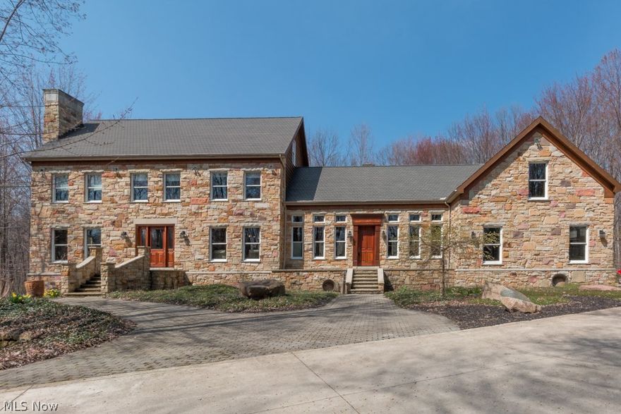 MORE ACRES CAN BE AVAILABLE! This custom built magnificent natural stone home features a first and second floor master bedroom, exotic wood floors and natural real stone floors on over four plus acres! The Great Room with its beautiful stone fireplace looks out to a tranquil setting with a spacious deck offering a built in grill area and plenty of room for entertaining.  Glorious kitchen with a sink in the center island, beautiful granite counters, all stainless steel appliances, beautiful cabinets.  Have your family gatherings in this spacious dining room with beautiful crown molding and built in ceiling lights.  The living room has a beautiful fireplace and wood floors.  Roomy stair case takes you up to three spacious bedrooms with room for a fifth.  Master bath with extensive walk in shower, beautiful tile work and three shower heads, sink with granite counter, and walk in closets. Fully finished walk out basement offers exercise area, plenty of room for entertaining, bathroom with