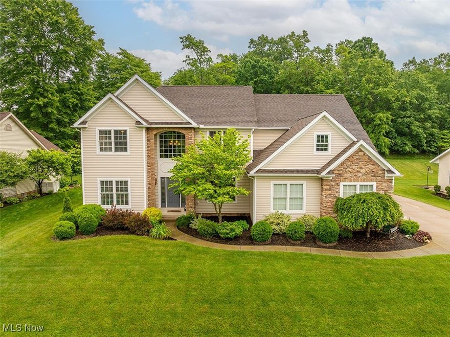 Come see this custom colonial built by Heritage Homes in the desirable Kings Ridge Neighborhood of Green. This gorgeous home has many amazing features and updates. The large two-story foyer makes a statement as you enter. A custom kitchen boasts beautiful solid maple cabinetry with new quartz counters and stainless appliances, a generous walk-in pantry, and an eat-in area well-lit by the large windows overlooking the quiet back yard. Off the kitchen is a small butler's pantry with extra storage, which can be used as a wine or coffee bar. The kitchen opens to the soaring family room with a grand two-story fireplace. In addition to the impressive living space, you will appreciate the first-floor office that can double as a 4th bedroom or guest room. The upstairs spacious bedrooms include a huge owner's suite with a seating area and two walk-in closets. Luxuriate in the master bath with his and hers vanities, large soaking tub, and huge spa shower with dual shower heads. Laundry is a breeze in the 2nd-floor laundry room. Outside, you will find a three-car attached garage with access to the basement with a full bath rough-in. The recently finished basement includes a soundproof office or a possible 5th bedroom, a built-in media center, half bath that is plumbed and ready for a shower to be installed. The tree-lined, private backyard is waiting for you to entertain or relax on the patio off the kitchen. The hot tub is currently on the patio and can be purchased with the home if desired. Don't miss touring this lovely home in its desirable location!