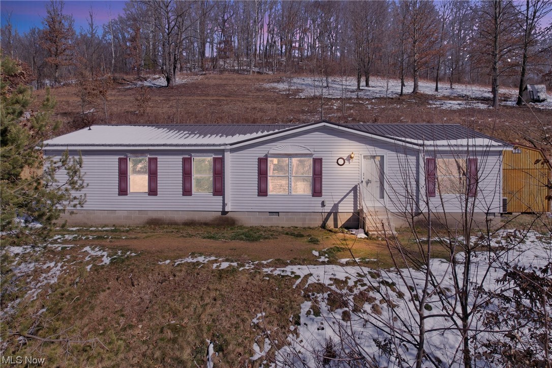 Affordable country living with beautiful scenic views on a hillside. Just over 3 acres of woods and is part of beautiful hunting country. Owner suite with large tub and separate shower and walk-in closet. Large dinning room is open to the kitchen. Several upgrades made throughout this property over the last 2 years include new roof, new carpet, new LVT flooring, excavation work of the hillside. You really need to see this property to truly appreciate the wonderful views. Selling as is.