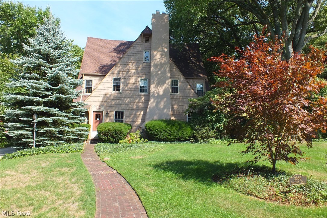 Located on one of the first streets officially established in Shaker Heights, this home was designed & built by Phillip Small to reflect an English cottage style home with gorgeous oak wood floors & beams etched with gorgeous woodwork details. Located close to the Shaker Lakes in the tri-school Shaker area, this home is also close to the RTA & Shaker Square for commuting downtown or to the airport. Dripping with gorgeous architectural detail inside, the first floor has built-in bookcases in the Tudor style Living Room with gleaming hardwood floors, a beamed ceiling & a sandstone wood burning fireplace. Formal Dining Room with chair rail & built in corner china cabinet & hardwood floors. Opens to 16 x 10 outside porch w/flagstone floor that overlooks a beautiful picturesque backyard with many perennial plants. Kitchen has hardwood floors, eating area & Butlers pantry. Second floor has 5 rooms with 2 full bathrooms & hardwood floors. Central Air was installed in 2016! Concrete driveway,