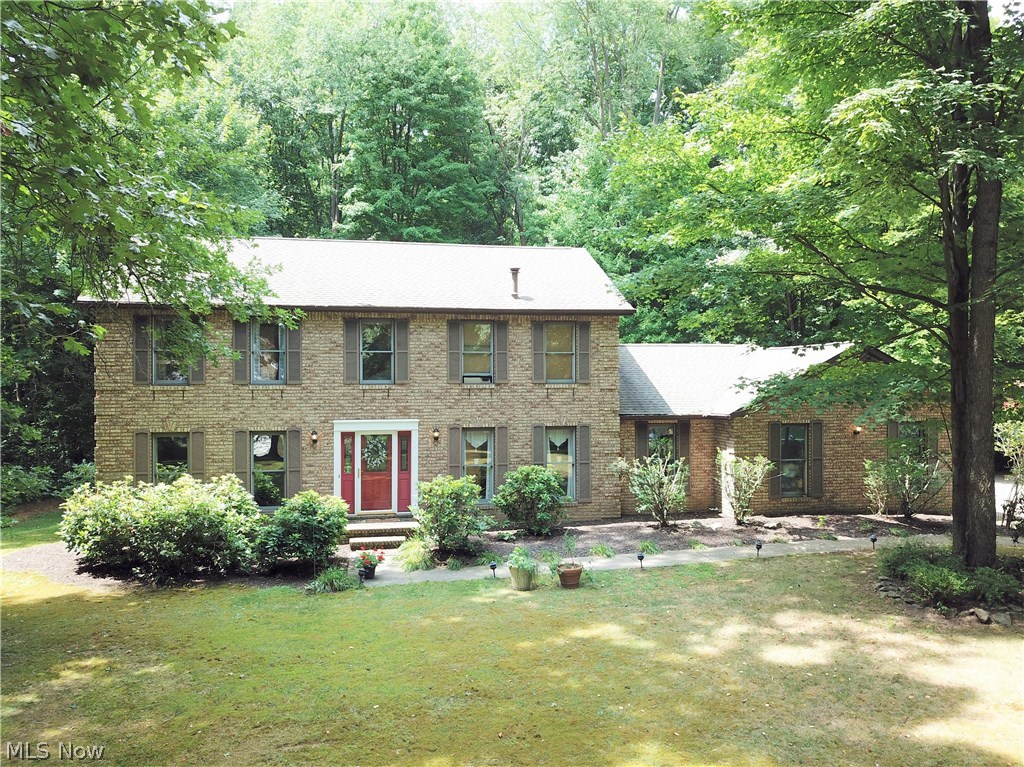Prepare to be amazed when you step into this beautiful brick colonial home in the Portage Lakes. 4 bedrooms and 3 full bathrooms, this home has numerous unique, beautiful features. You will immediately notice the beautiful hardwood floors featured throughout almost the entire house. Recently remodeled kitchen featuring custom designed solid natural maple cabinets. The L-shaped island provides even more storage and food preparation space, as well as a breakfast bar seating area. Newer black kitchen appliances come with home. Off the kitchen, there are French doors that lead into the dining room with cathedral ceilings and large windows with views of the private fenced in backyard. When you step into the living room, you'll immediately fall in love with the large stone fireplace -- it's gorgeous! All three of the bathrooms are updated and modern. Master bedroom has a fireplace and vaulted ceilings. The basement has a finished family room. Brand new central air was installed(2018) & newer