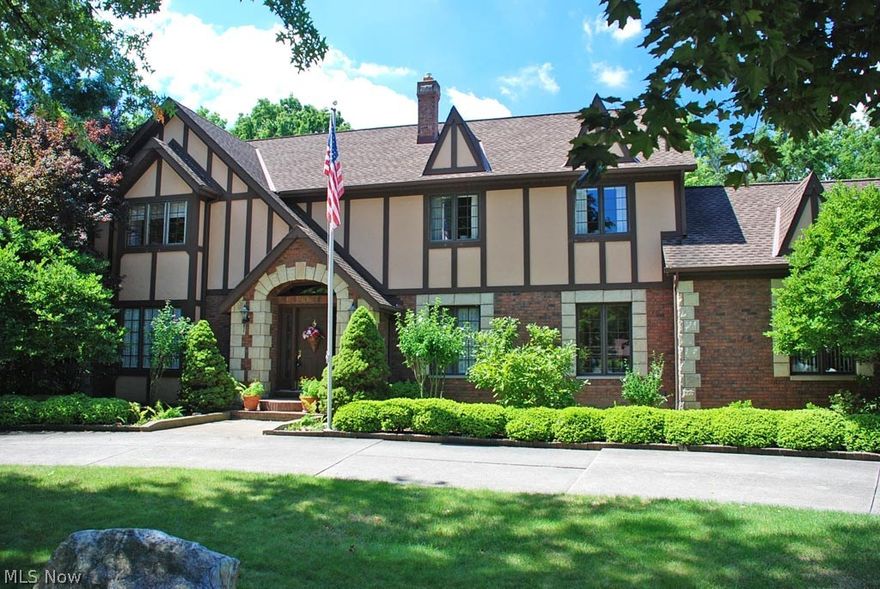 From the moment you drive up the circular driveway and admire this substantial, all-brick, tudor-style, center-hall colonial w/stone accents, your expectations will be surpassed as you walk into the 2-story foyer w/a circular staircase. Lg, light-filled liv rm w/a box-bay window. Office/study w/French doors & wainscoting. 16x13 din. rm with hw floors, crown/chair moldings & bay window overlooking the peaceful backyard. Kitchen is a classic layout w/window overlooking the 3-season sunroom. Fam rm w/wbfp, beamed ceiling & built-ins. Main-level laundry w/built-in ironing board & closet. Sep. hallway with ceramic flooring from garage & sep exit to rear yard. Sunroom has entrances from both kitchen &  family room and exits to the backyard. Backyard is a delight with raised garden beds, 6 fig trees, brick patio, gazebo, shed w/concrete slab. 2nd level features mstr br w/large walk-in closet & door to extra unfin space over garage for addl storage. 3 generous sized bedrooms share a hall bath.