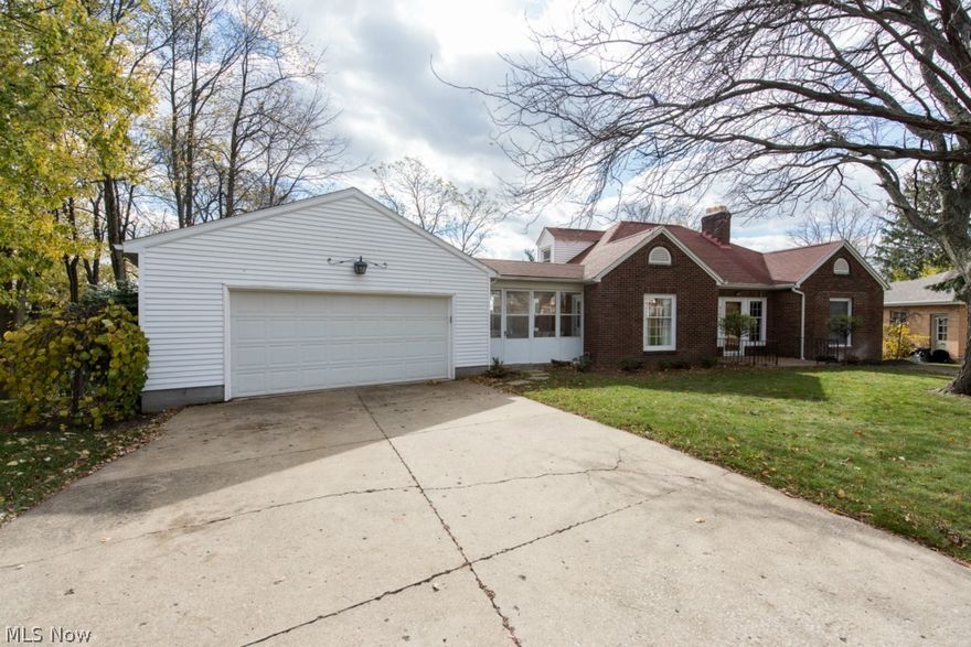 Most people don't even realize this charming street exists! First impressions count as you drive down the red brick street to this home. With over 1800 square feet, this brick, cottage style home offers such a unique and versatile floor plan. The first floor is fantastic and you will soon notice the beautiful hardwood floors when you step in the front door. The living room is adorned with a fireplace and built in shelving that surrounds the front door. The living room opens right up to the formal dining room with additional built ins and a picture window offering a fantastic view of the half acre lot. The large kitchen features all appliances, tile floor, and a pantry area. This is a 3/4 bedroom home providing two bedrooms on the first floor, full bath, plus a potential fourth bedroom currently used as an office. Off the office is a cute sunroom which connects to the garage. On the second floor is a darling bedroom with its own half bath. The walk out basement would be perfect to finis