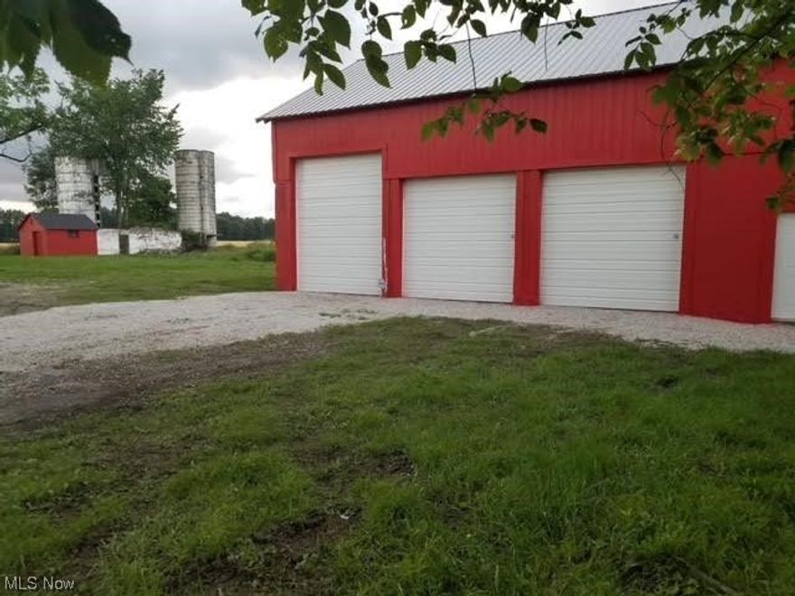 OWN YOUR OWN OASIS CAMPGROUND WITH  BOATING,HUNTING, FISHING OR BUILD YOUR DREAM HOME ON THIS BEAUTIFUL PRIVATE  almost 12 acre sprawling property. Owner has done many improvements:The huge 45' x 42' garage has been renovated with newly made stairs to upper attic storage; new 200 amp electricity , new ighting, Wifi, Brinks Alarm system and Ring with cameras; new metal roof and new gutters, 3 new garage doors with garage door opener on large 10' x 12'  door, other 2 doors sizes are 10'x10'.There is a 300 Galloon rain water collection tank which stays. Forty tons of gravel completed a circular front driveway and a convenient RV parking spot along with posts strung with edison lights. Heavy equipment was brought in removing old barn foundation along with other old foundations and clearing overgrown land and drainage ditches were dug improving surface water excess. Owner converted utility building to a modern type chicken coop housing 9 chickens complete with heated rain water collection system and automatic dawn/dusk access door. Docks added to 2 of the 3 stocked ponds, all of them now with plenty of  Bass and bluegill.Owner also added a tree stand for deer hunting and a large enclosed house stand on metal frame. The large house stand ia 6'x8' with windows on all 4 sides and trap door access . Walking and ATV riding trails were added around the property perimeter. Land in summer/fall is solid and can be driven on completely to back of property .With improvements that were made. fields are healthy in front half and on back portion of the property. There are also fruit trees and 2 older silo on property. Extremely quiet paradise with no close neighbors! The property is between professionally farmed land and two other commercial properties. Deer, turkeys, squirrels, and rabbits inhabit the property.. Sunset views here are absolutely breathtaking!