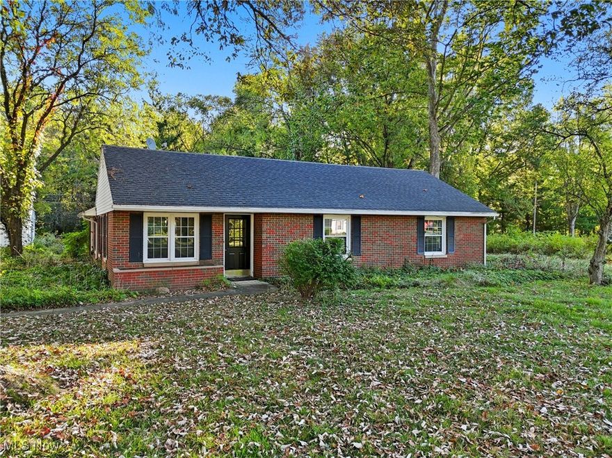 Welcome to this charming 3-bedroom, 1.5-bath brick ranch in Hudson, set on a spacious .7-acre lot. The inviting main living and dining rooms feature beautiful hardwood floors and flow into the kitchen, complete with a gas stove and ample cabinet space. Three nicely sized bedrooms share an updated hall bath, while large windows throughout the home provide abundant natural light. A cozy back family room offers views of the private backyard, perfect for relaxing or entertaining. A separate laundry room and convenient half bath complete the layout. Outside, you’ll find a detached oversized 2-car garage along with a large shed for all your storage needs. With so many possibilities, this home is a wonderful opportunity to make your own in the heart of Hudson! HVAC-2024, Water Tank-2022, Roof-2002, Windows-2005