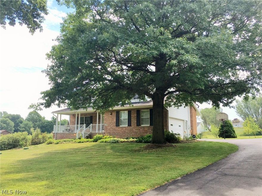 Smithville School District ~ Lovingly cared for home on 2+ acres with garden space, numerous fruit trees and berry bushes, 24x30 outbuilding with 2 overhead doors for additional garage parking, as well as 2 exterior water hydrants for all of your watering needs!  The inviting covered front porch with low maintenance vinyl railings offers a peaceful, wooded view across the road.  Upon entering you will find to your left the living room, and to your right a half bath, and cozy family room with abundant natural light and wood burning fireplace insert. The kitchen with beautiful hardwood flooring which flows into the dining room is open to the family room. Newer carpet can be found throughout the home.  The large master suite has 2 closets and private bath with stand up shower.  3 additional bedrooms and guest bath with ample storage completes the 2nd floor.  The lower level has a half bath,  finished living area with ventless gas log fireplace and a walk-out doorway that leads to a covere