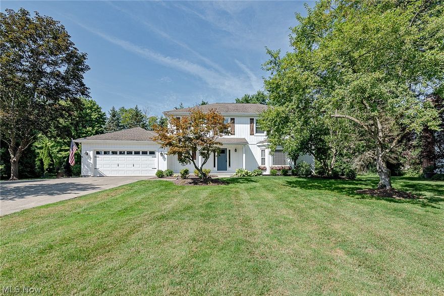 Move right in to this picture-perfect colonial in Chagrin Falls! This delightful home features a classic floor plan, a gorgeous white kitchen, and a luxurious master suite. All that is missing is you! The foyer flows into the spacious living room, which features a bay window. The dining room is open to the living room, and features large windows, crisp chair railing, and a tray ceiling. You will absolutely love the kitchen, which includes an island, stainless steel appliances, and a sunny eat-in area. The kitchen is open to a gorgeous family room with a beamed ceiling, a brick fireplace, and deck access. A half bathroom and a convenient laundry room with built-ins completes the first floor. Upstairs, you will find four spacious bedrooms and two full bathrooms, including the master suite. The master suite includes a walk-in closet, a balcony, and an elegant en-suite bathroom with two vanities, a soaking tub, and a step-in shower. The full lower level is finished with a large rec room, a