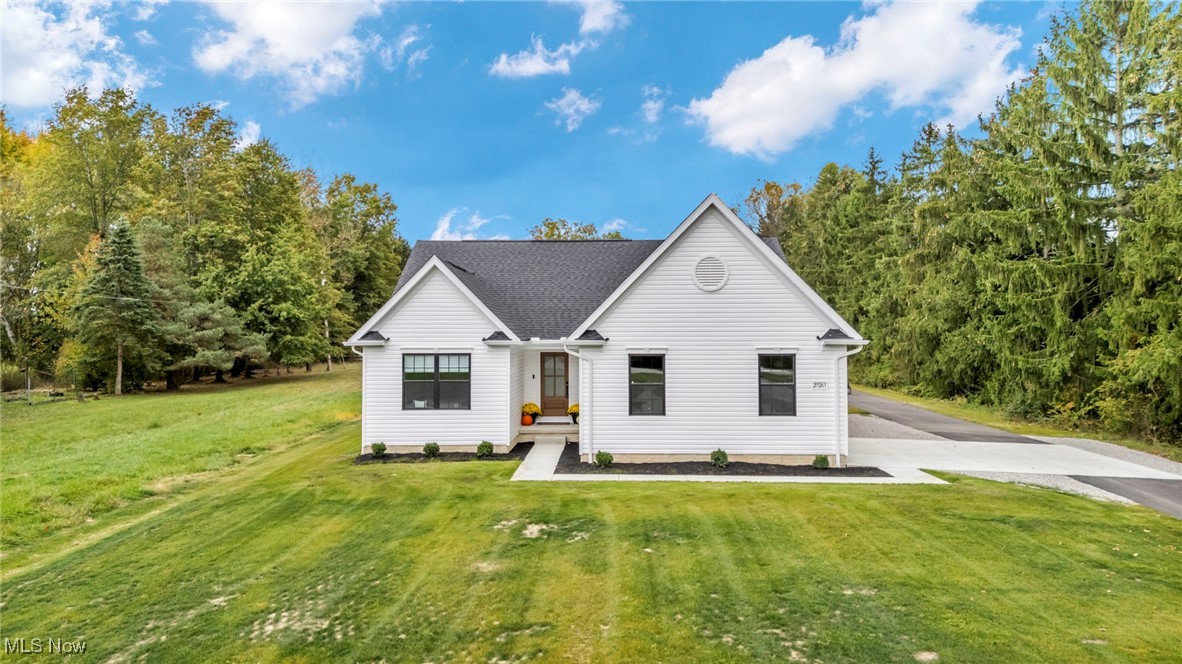 Welcome to this newer, custom-built ranch nestled on nearly 5 scenic acres in beautiful Olmsted Township! Thoughtfully designed, this 3-bedroom, 2-bath home blends the serenity of country living with modern conveniences just minutes from shopping, dining, and major highways. Step inside to discover an inviting open floor plan highlighted by vaulted ceilings, durable luxury vinyl plank flooring, and abundant natural light. The spacious living room flows seamlessly into the gorgeous eat-in kitchen, complete with a large center island, quartz countertops, stylish backsplash, and all kitchen appliances included. A bright dining area opens to a partially covered patio, offering the perfect spot to relax or entertain while enjoying peaceful country views. Additional highlights include matte black hardware, 5¼-inch baseboards, main-floor laundry, a paved driveway, and an oversized 2-car attached garage. The full basement is plumbed for a future full bath, providing excellent potential to finish into additional living space, a recreation area, or ample storage. For equestrian enthusiasts or hobbyists, the property features an impressive 130' x 33' barn/outbuilding with 25 stalls and a fenced dry lot,  ideal for horses, livestock, or flexible use. Enjoy the best of both worlds,  privacy, acreage, and open space, combined with quick access to North Olmsted shopping, Great Northern Mall, local parks, and nearby I-480 and I-80. This exceptional property offers the perfect balance of modern comfort and peaceful country living.