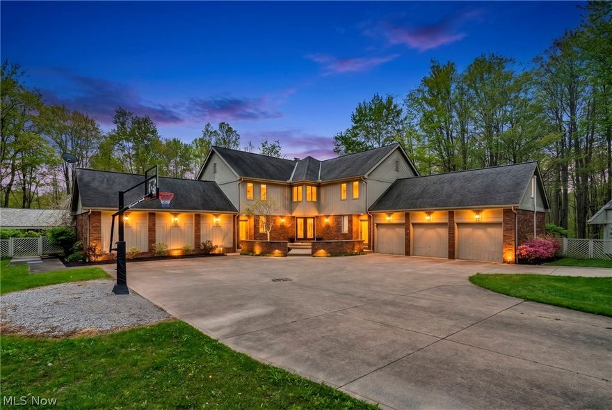 Nestled on a breathtaking wooded lot on the Richfield/Brecksville border, this exceptional custom-built residence offers the perfect blend of luxury, privacy, and resort-style living. A dramatic two-story foyer with a curved staircase welcomes you into expansive living spaces filled with natural light.

Designed for entertaining and everyday living, the home features a vaulted great room with a floor-to-ceiling fireplace, a spacious entertaining area with wet bar and loft overlook, and a private office with custom built-ins and coffered ceiling.

The four-season room overlooks the spectacular backyard oasis featuring a resort-style in-ground pool, spa, waterfall, pool house with half bath, and expansive patio surrounded by mature trees and lush landscaping.

The spacious kitchen opens to the main living areas and offers abundant cabinetry, generous prep space, and peaceful outdoor views. Rich woodwork and oversized windows are found throughout.

Upstairs, the primary suite features a gas fireplace, two walk-in closets, and an en-suite bath with soaking tub, granite double vanity, and spacious shower. Additional bedrooms include a Jack-and-Jill bath, private en-suite bath, and a finished bonus room over the garage ideal as a bedroom, playroom, or gaming room.

The recently finished lower level adds 880 sq. ft. with a full bath, wet bar, rec room, and wood-burning fireplace.

Outside, enjoy a large heated outbuilding with electric, water, and workshop space, perfect for extra cars, a boat, or RV storage, plus a 3-car attached garage.

This one-of-a-kind property offers incredible entertaining spaces, privacy, and convenience near highways, shopping, dining, and top-rated schools. A truly rare opportunity to own your own private retreat