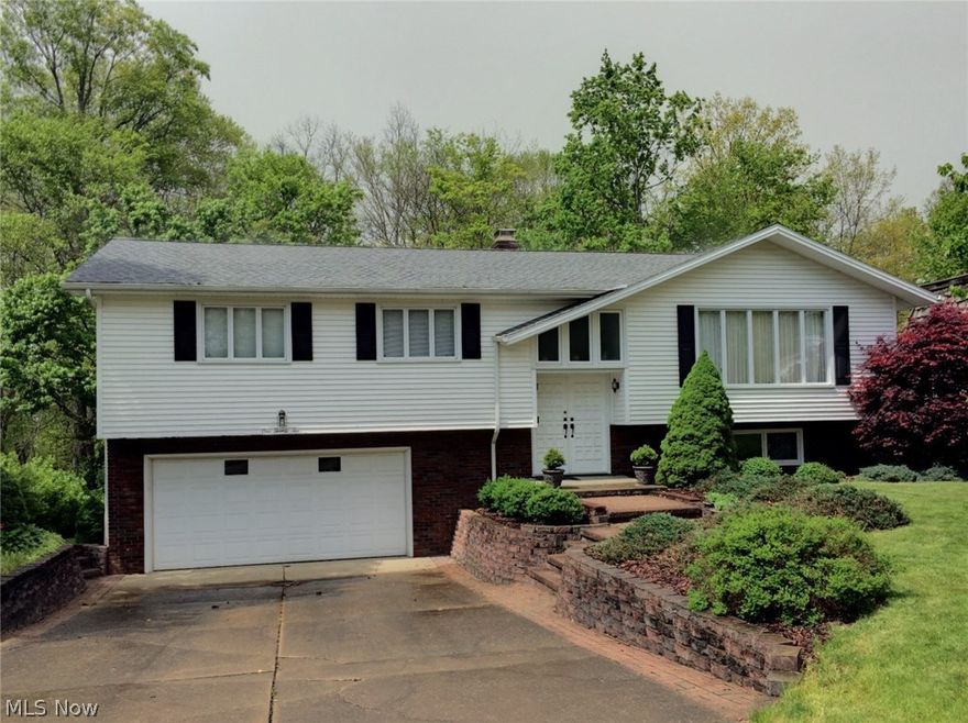 GORGEOUS!! Extremely well kept single owner home in a park-like setting. Bi-level featuring 3BR, 2.5ba, walk-out basement and double enclosed patios. Upper level boasts an updated kitchen with beautiful cherry cabinets and stainless steel appliances, formal dining room and living room. Master bedroom includes an UPDATED attached full bath.  Family room with fireplace, half bath, and BRAND NEW carpet on the lower level. Roof replaced in 2012. Seller offering one year home warranty.