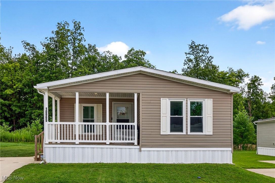 Welcome home to this beautiful 3 bed, 2 bath double wide mobile home in Leaders Park! A nice size lot offers wooded privacy in the back, space for entertaining, brand new side steps, and new 10x14 shed. The covered front porch leads inside to the open concept great room, dining room, and updated kitchen where you'll find a large island with bar seating, new solid surface countertops (2024), painted cabinets, dishwasher 2025, new backsplash, and a farmhouse sink. New LVT flooring throughout was installed in 2024 and all but 2 windows are new over the last couple of years. The laundry room includes brand new shelving for your storage needs and a mudroom entry from the outside. The master bedroom is generously sized and has his and her closets, a ceiling fan, and en suite bathroom with a double vanity, garden tub, and walk-in shower and there are two other large bedrooms. Of now, this home has crown molding throughout and the sellers have added feature walls and floating shelving, too. The park has a pavilion and clubhouse which can be rented for a small fee and the water/sewer/trash are included in the lot rental. At 115k brand new and all the additions completed in this home, the price is right! Schedule your showing today!