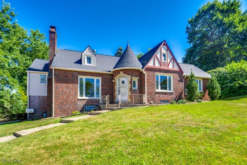 Step into a piece of Canton City history at 3153 Landscape Circle NW! This cozy tudor is hidden on a beautiful street and so perfectly placed that you will feel at home before you even get inside! From the turret to the terrace, the charm is unmistakable. The best part is that it has all of the updates but did not lose a bit of character! With new paint throughout, original quarter-sewn oak flooring has been refinished, ALL NEW kitchen, and brand NEW roof. Windows are updated and great quality as well as the gutter system. Seller believes they are around 10 years old. It is immaculate, open, and spacious! There are so many ways to use the square footage this home offers. This kitchen has the original built-in's too and a small nook for eat-in but also a full dining room right off of it as well. Another door off of the kitchen opens into the huge addition that you could use for larger dining, living room, or both! Entertaining in this room with a vaulted ceiling and natural light will have you feeling like you are out on the town while living it up at home! The full upper level could be separate living space for family, tenant, or caretaker or just more room for your family! The attic space is even fun! It has a main staircase but also a back one for entry or exit that is private. The basement is amazing for entertainment too! Enjoy the perfectly preserved vintage wet bar with sink and drain, and plenty of space for pool, darts, tables, etc. There is another full room for storage and/or extra living space in the basement too. A walkout to the garage is down there as well as a bathroom and laundry area. Last but not least there is a security system installed for peace of mind. Close to shopping, restaurants, Plain Local Schools, highway access, and more. Words simply cannot tell you what your heart will say when you come see this place for yourself. Call today and see the house you have been waiting to make HOME!