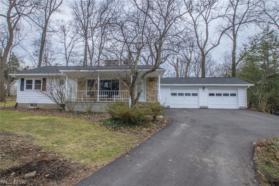 Tucked away in an established mature neighborhood & away from the hustle and bustle--yet close to Routes 43 (Kent, points south) and 480 (Streetsboro, points north)--this ranch home boasts wide front porch, 2 wood burning fireplaces, very spacious lower level knotty pine family room with fireplace and a beautiful wooded lot... among other things! Experience the natural surroundings close to hiking, sledding, cross country skiing and lake views at Twin Lakes, Lake Rockwell and Towner's Woods! You'll appreciate the beauty of original wormy chestnut in the Living Room and hardwoods in hall and bedrooms! And enjoy incredible number of UPDATES including: the newer windows throughout, total roof replacement, new furnace and central A/C all in 2014! Bath was remodeled and includes Bathfitter surround. Kitchen slider was added as egress to back yard in 2014. Kitchen updates include KitchenAid stove, wood laminate flooring, Bosch dishwasher, sink and countertops. As well, wood laminate flooring