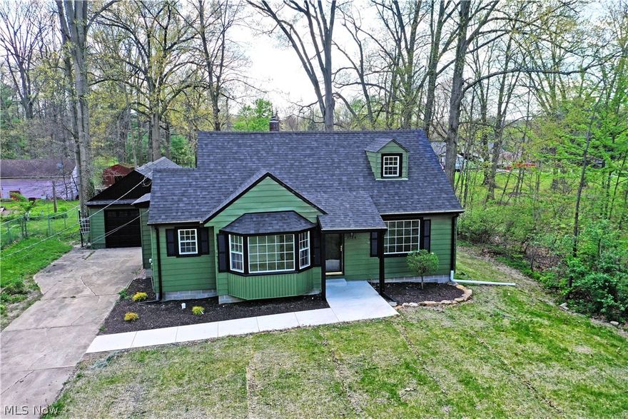 Colorful, cute and ready to excite with a fully renovated and modern interior; this engaging Mineral Ridge home is bringing the heat! Rich, green and black colorways present a sleek, modern appearance that stands out from its peers, all while a freshly landscaped cement sidewalk brings you inside. The cement driveway finds an extended length garage that fits two or more vehicles within its single file layout. A neighboring sunroom is an added bonus. Inside the home, beautiful vinyl flooring is warmed with plenty of natural light from the large, lattice lined windows. An immediate living room transitions into a central dining space with recessed lighting and a stunning, bay window. The daring kitchen finds custom stone countertops and a tiled backsplash as the modern, stainless appliances brighten things up. Casual dining space is located past the basement entrance. Meanwhile, a pair of spacious, first floor bedrooms complete the level as they flank a bright and tiled full bath. Upstairs, a third loft bedroom offers carpeted flooring as it sweeps the length of the home. A second half bath and storage can be found at the basement level.